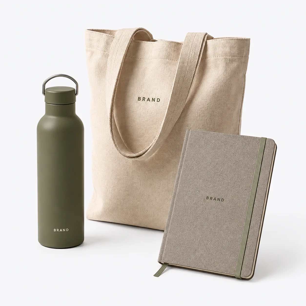 Reusable bottle, natural canvas tote and recycled-material notebook