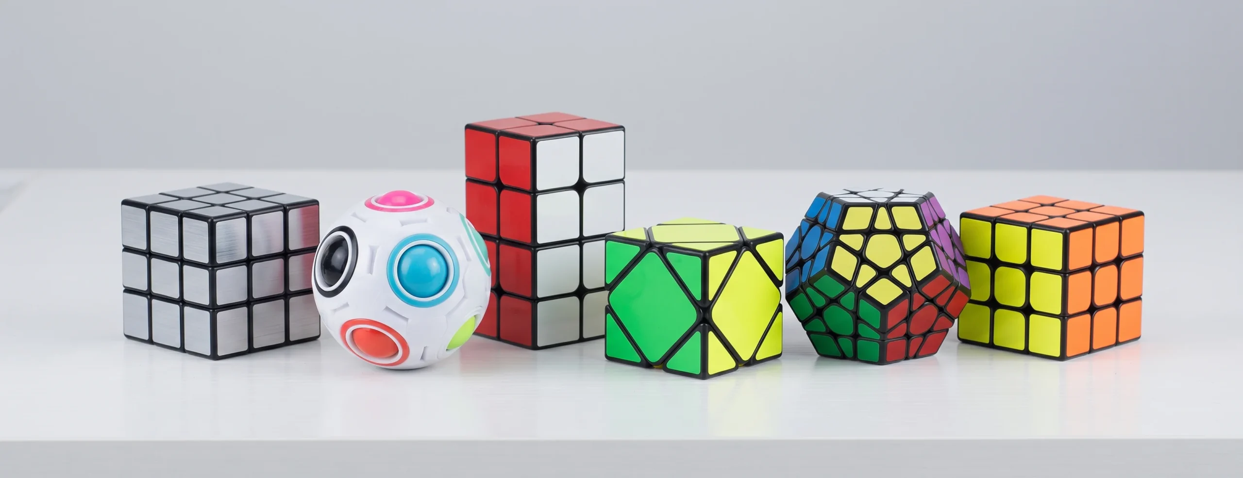 Wide introduction banner showing a custom irregular speed cube set on a minimalist desk