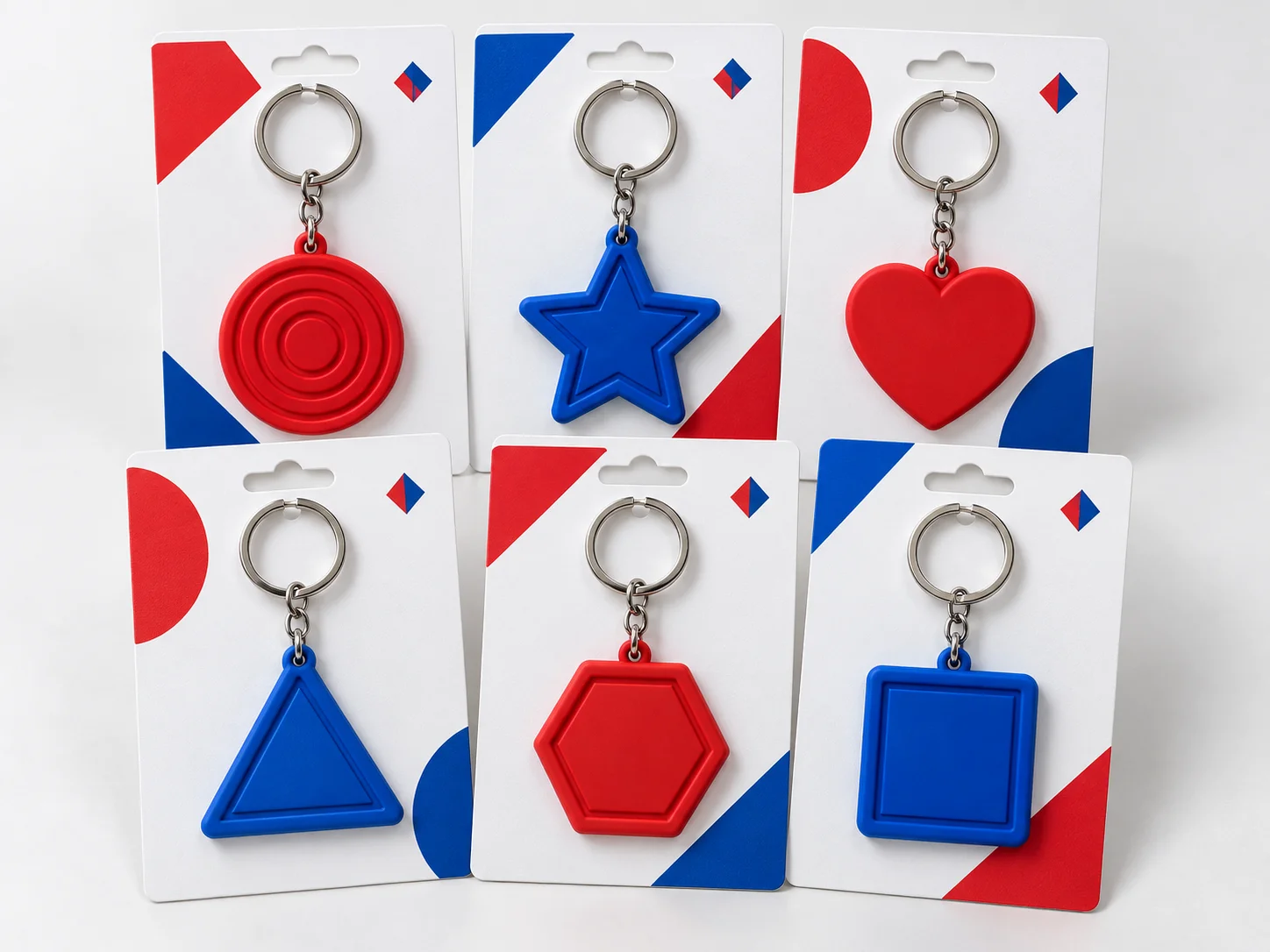 Red and blue promotional PVC keychains displayed on branded backing cards