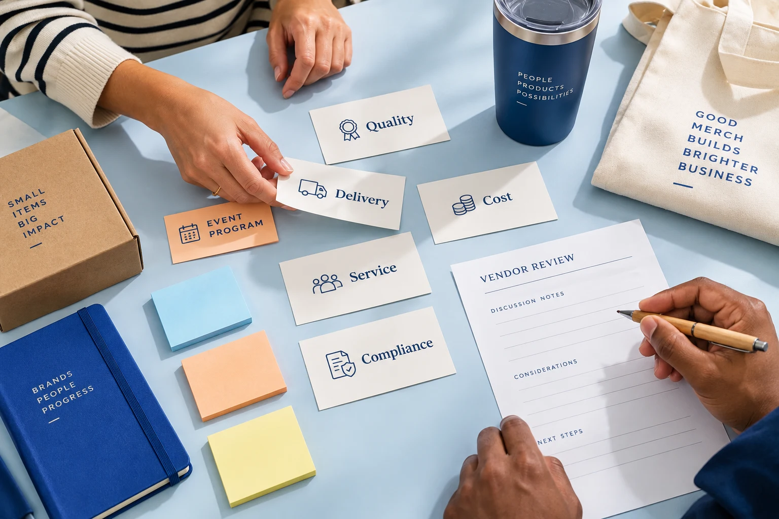 Procurement paperwork and promotional gift samples arranged for a vendor scorecard review.