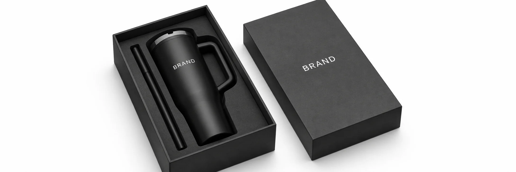 Black handled tumbler in a fitted charcoal presentation box with a separate straw channel beside the matching box lid.