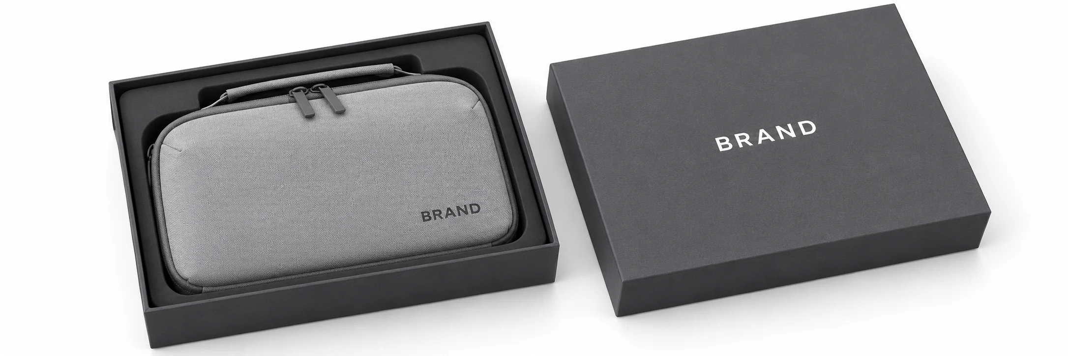 Gray handheld organizer with dark lettering inside a fitted charcoal presentation box beside its matching lid.