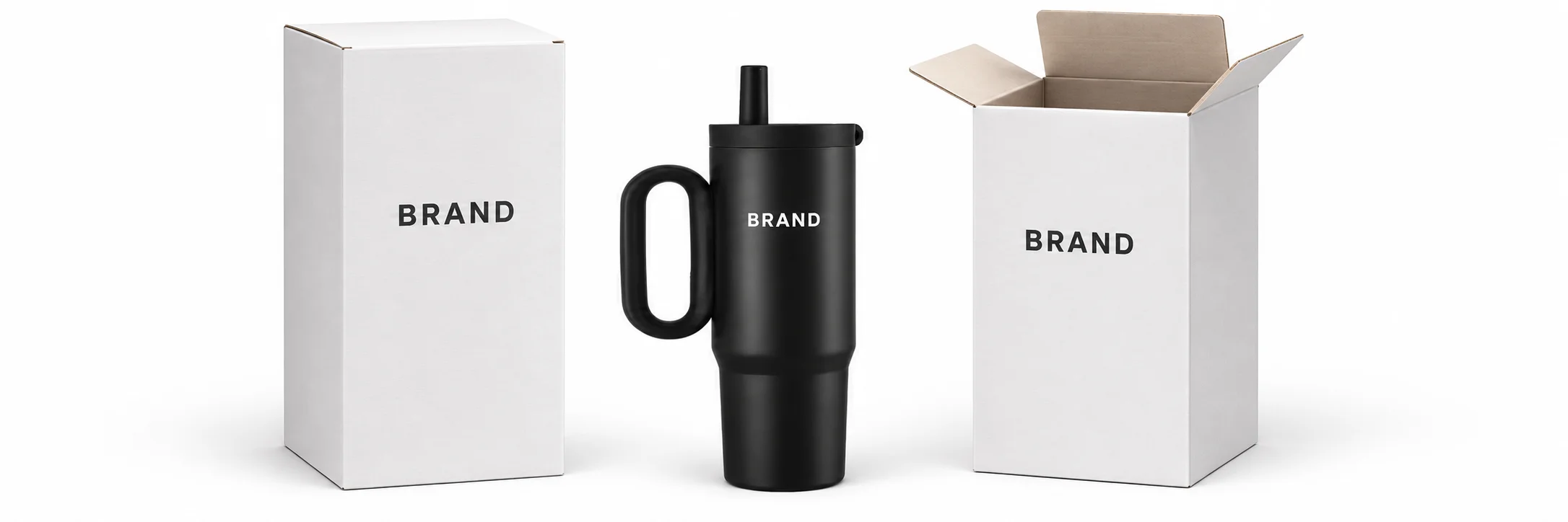Black handled straw tumbler beside open and closed white paperboard boxes