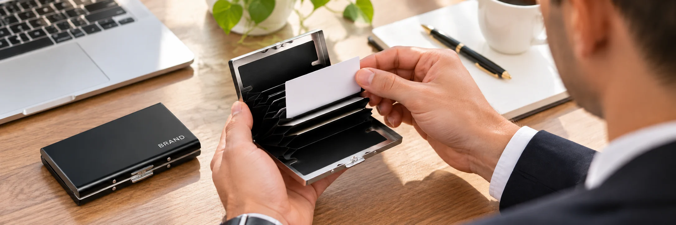 Professional taking a business card from a black metal card holder