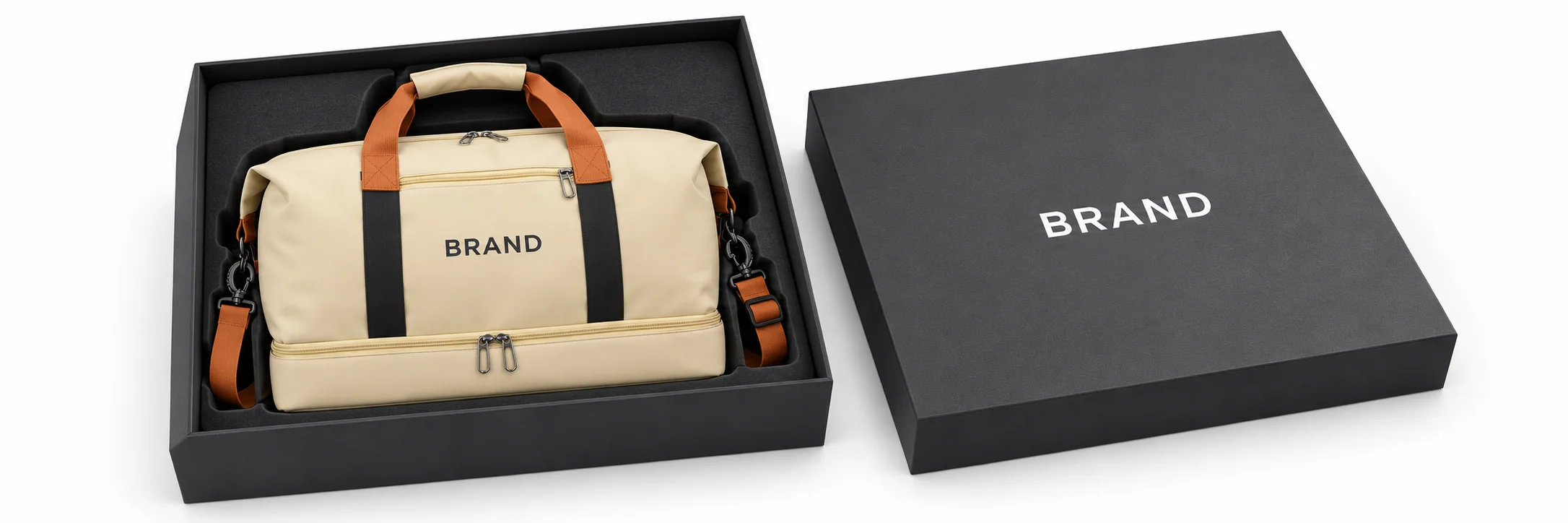 Cream Oxford duffel with dark lettering inside a fitted charcoal presentation box beside its matching lid.